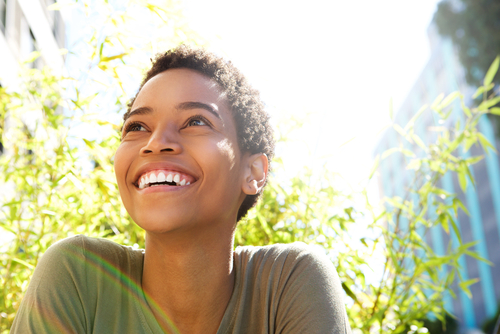 woman smiling on a bright and sunny day