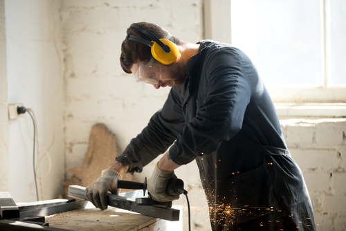 Man working with machinery while using eye protection